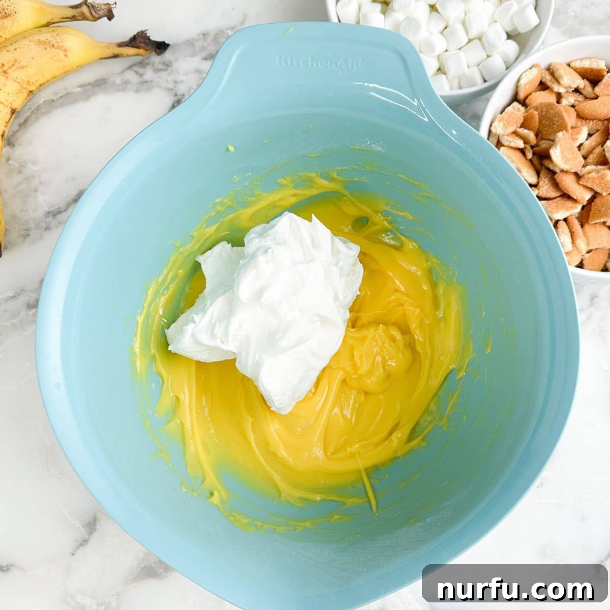 Bowl with vanilla pudding and whipped topping.