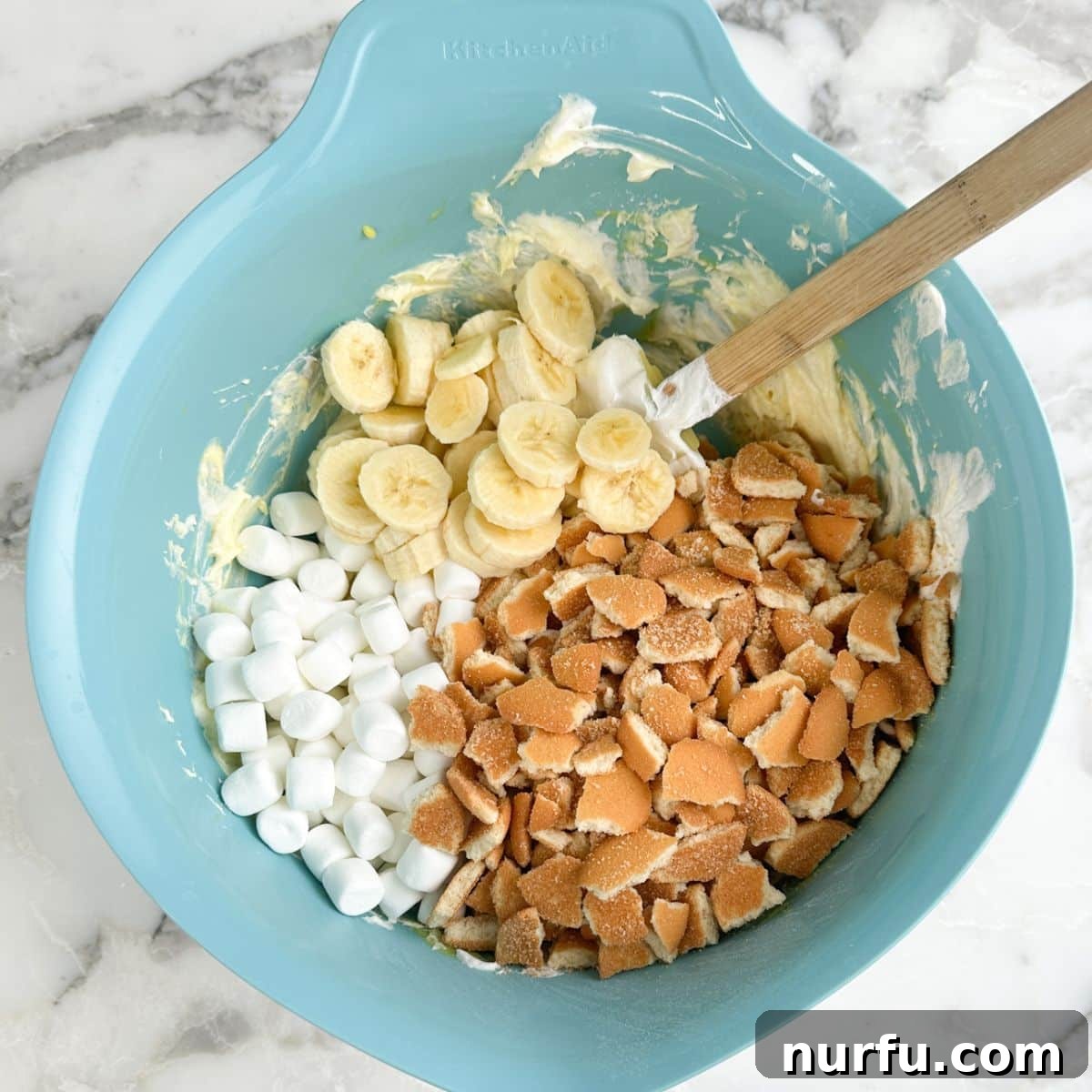 Bowl with vanilla pudding, bananas, mini marshmallows, vanilla wafers.
