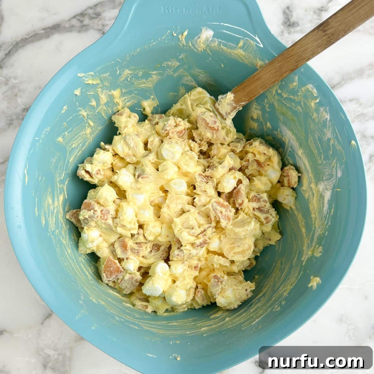 Bowl of banana pudding fluff with a spatula.