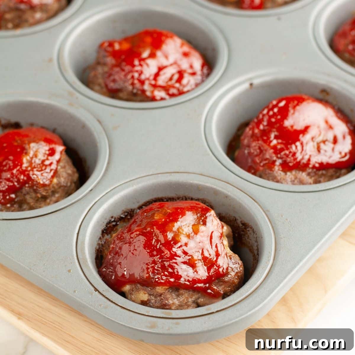 Mini Meatloaf Muffins Recipe with Cheesy Center 6 Muffin tin with mini meatloaf muffins.