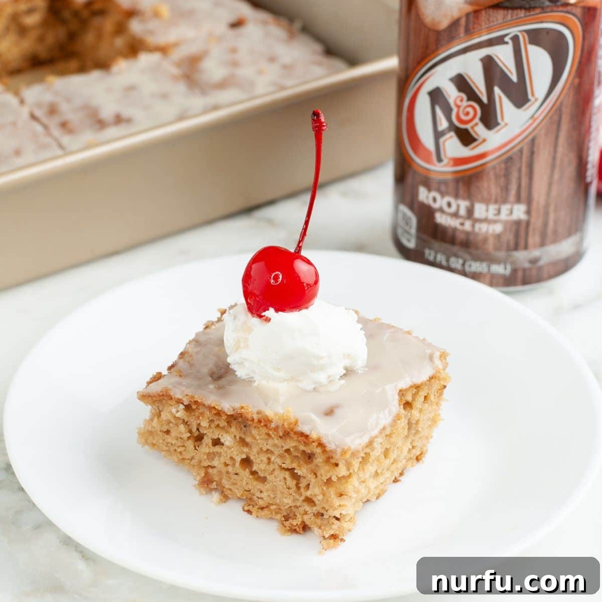 Plate with a piece of root beer float cake and a can of root beer. 