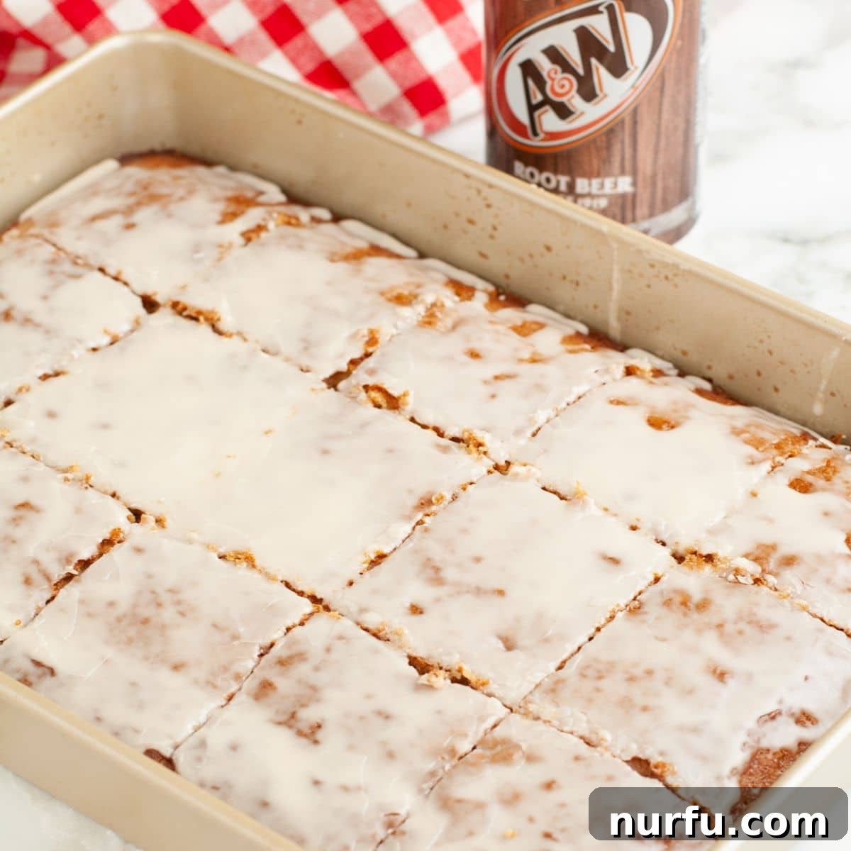Pan with root beer cake topped with glaze. 