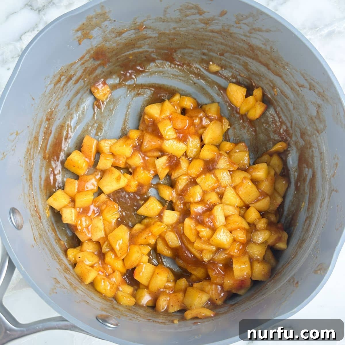 Saucepan with peach pie filling.