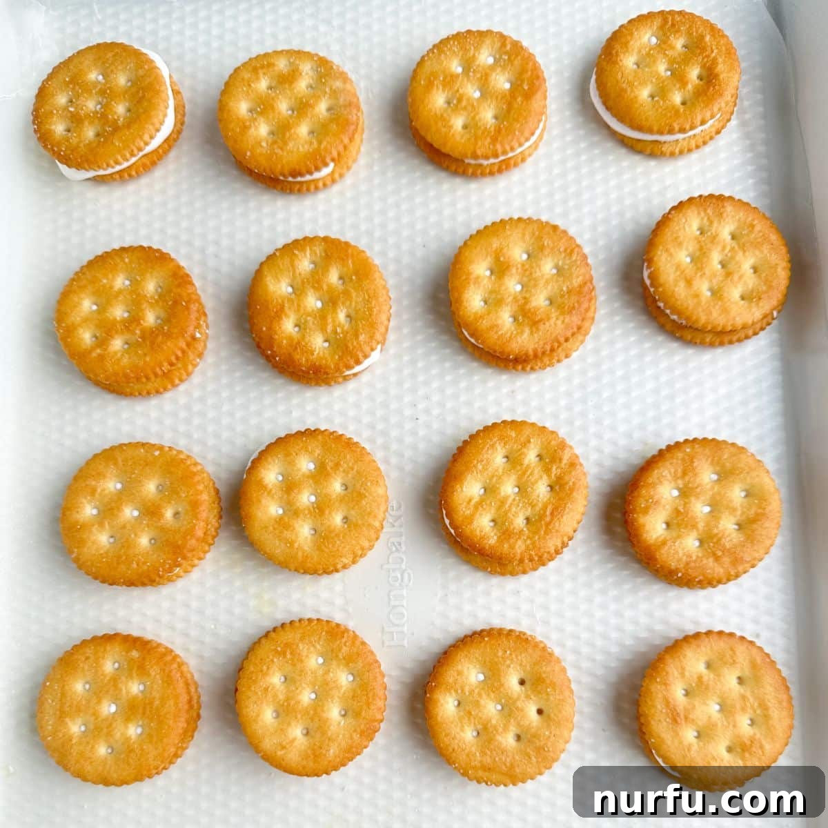 Baking dish with Ritz crackers filled with marshmallow creme. 