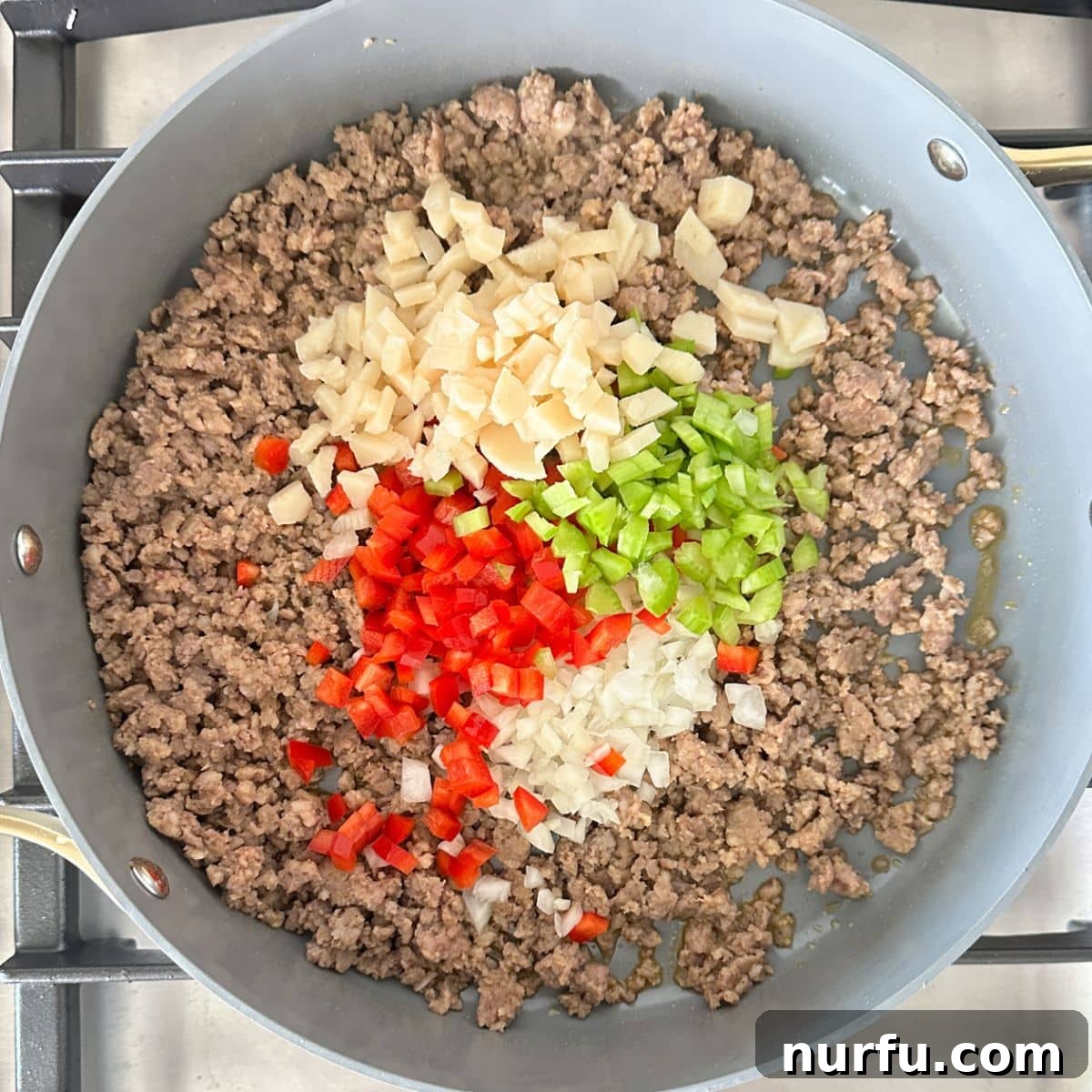 One-Pan Sausage and Rice Casserole 4 Skillet with ground sausage, diced pepper, celery, onion, and water chestnuts.