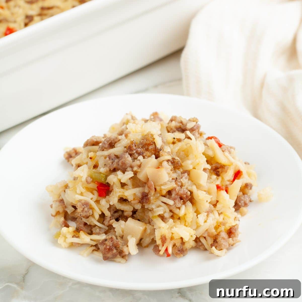 One-Pan Sausage and Rice Casserole 9 Plate with sausage and rice casserole.