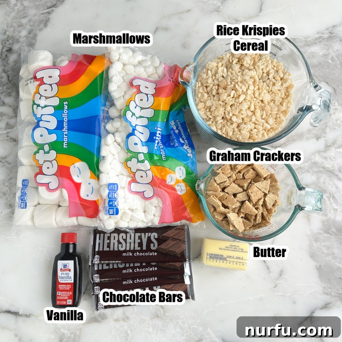 Bag of marshmallows, Rice Krispies, chocolate bars, broken graham crackers, vanilla, and butter.