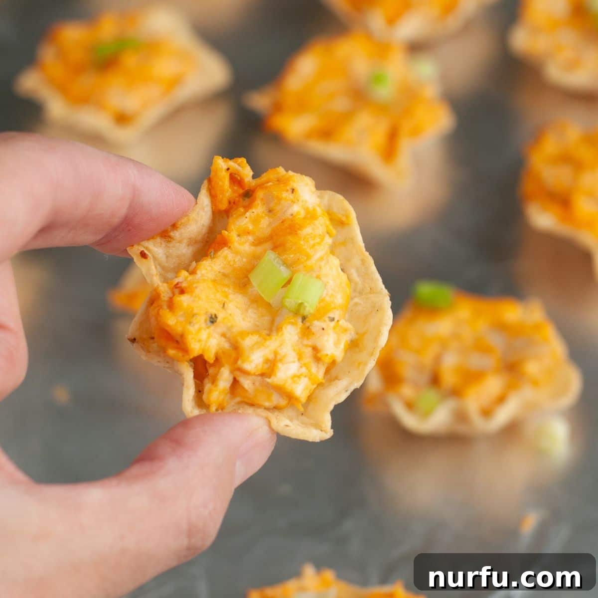 Buffalo Chicken Dip Bites Recipe for Game Day 6 Hand holding a buffalo chicken dip bite.