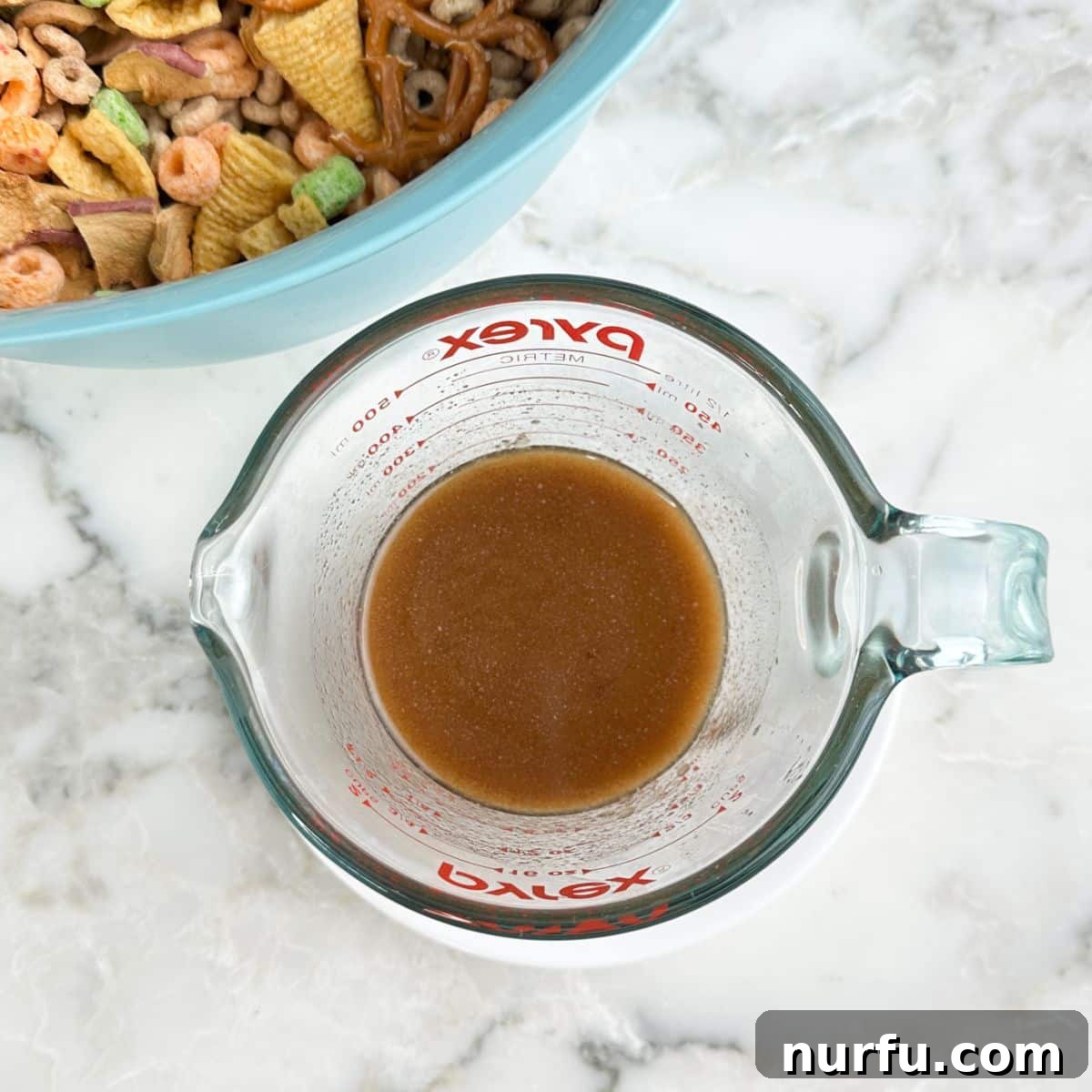 Crispy Apple Pie Snack Mix with Cinnamon & Caramel 5 Bowl of melted butter with apple pie spice.