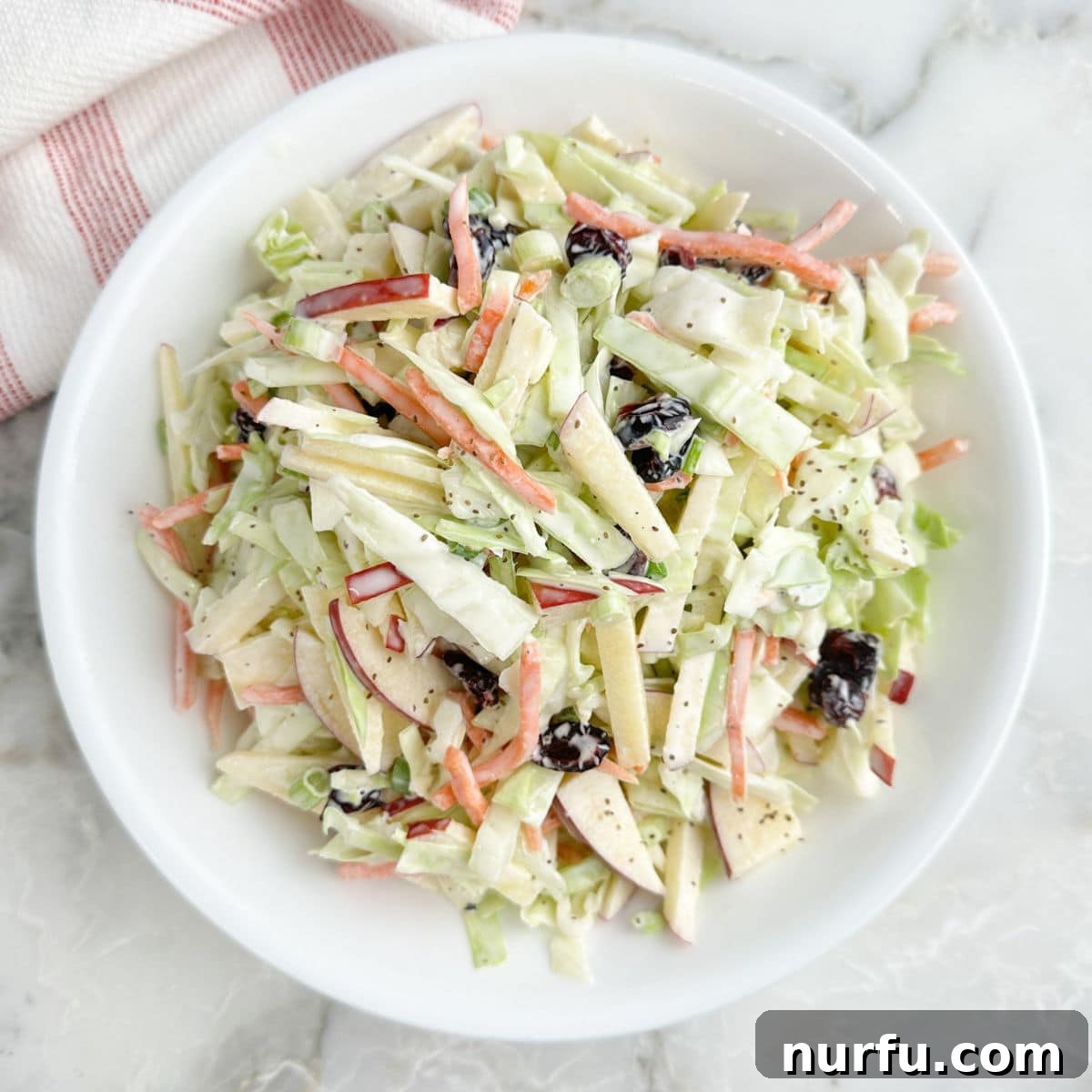 Crisp Apple and Cranberry Slaw with Maple Dijon Dressing 6 Bowl of cranberry apple slaw.