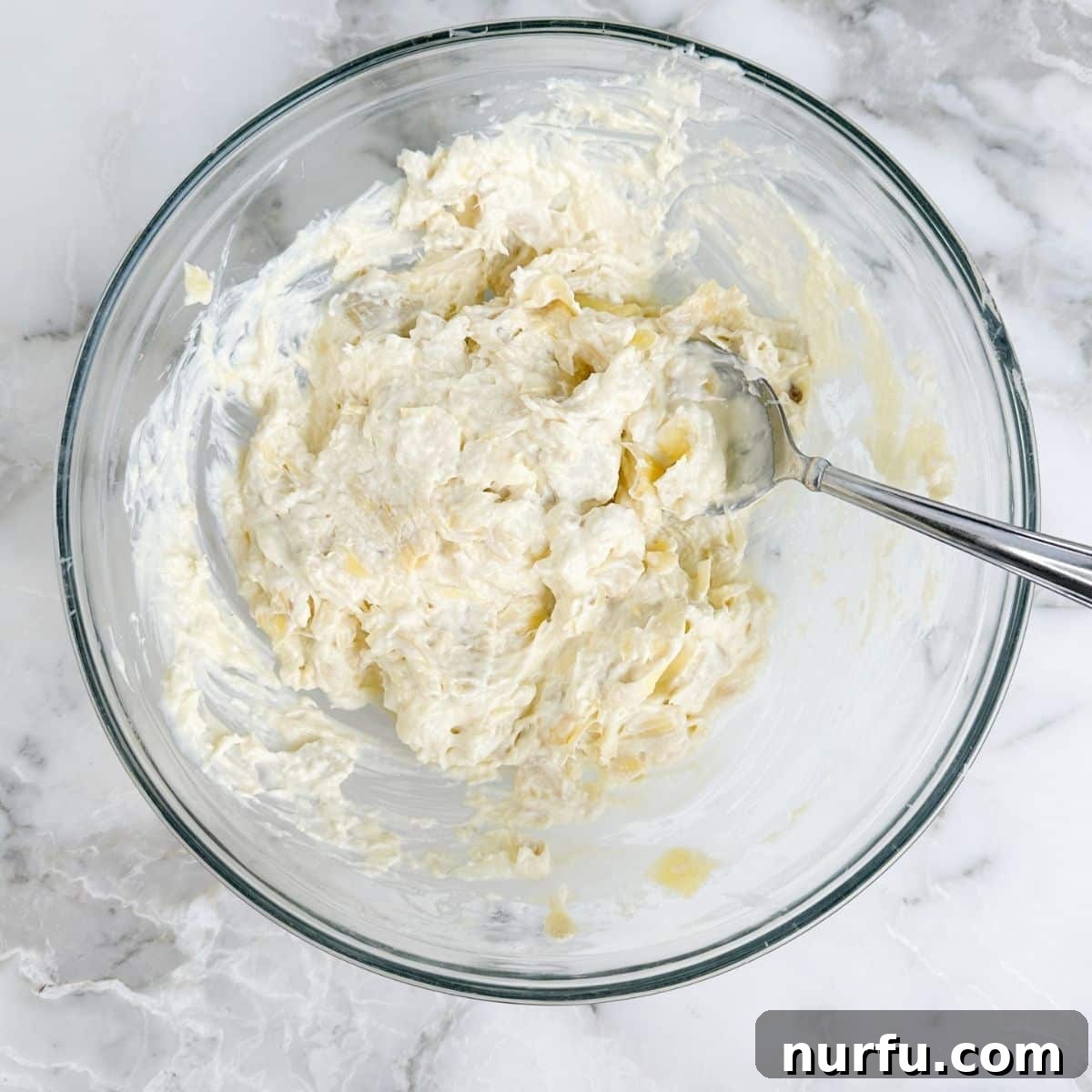 Bowl of artichoke dip mixture. 