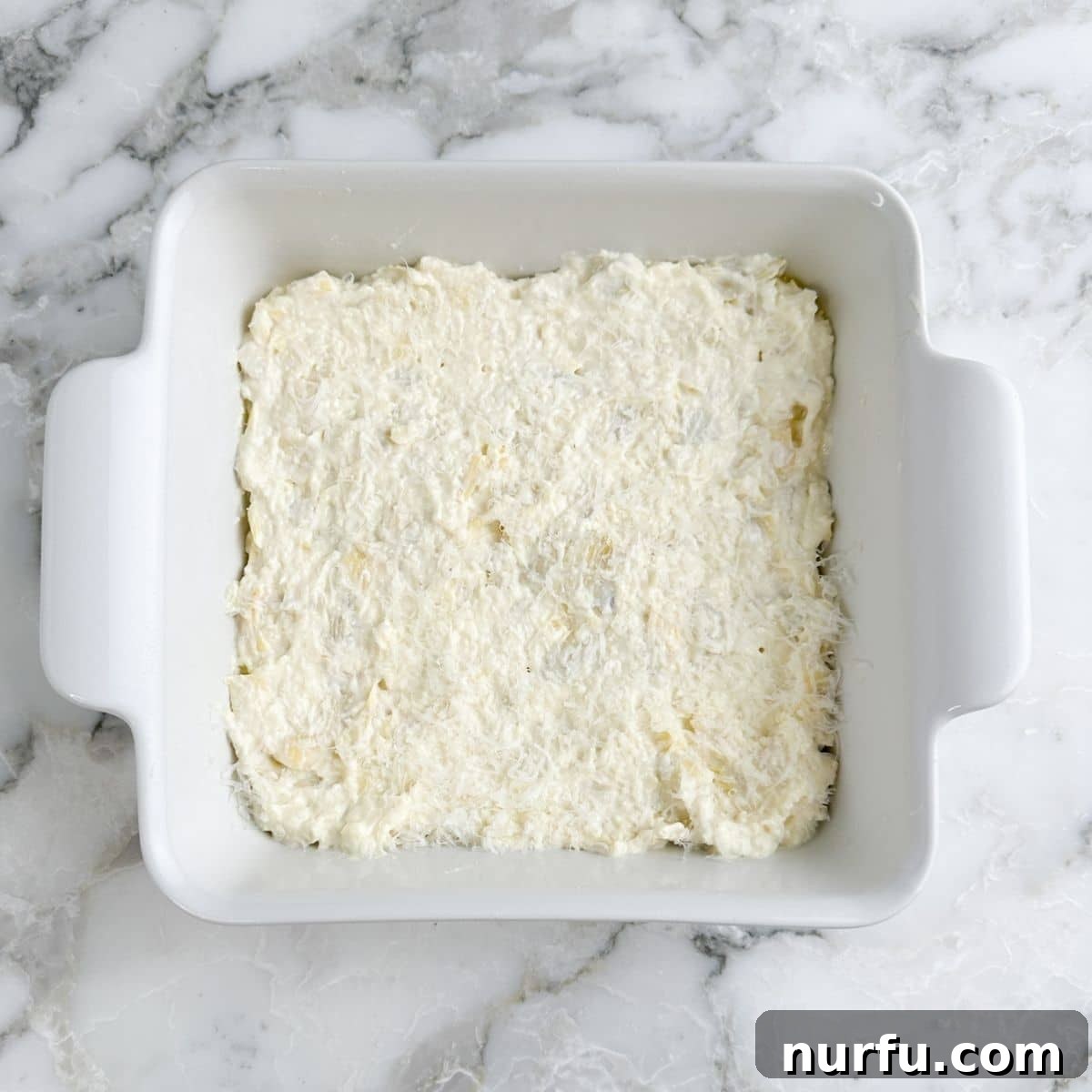Baking dish with artichoke dip. 
