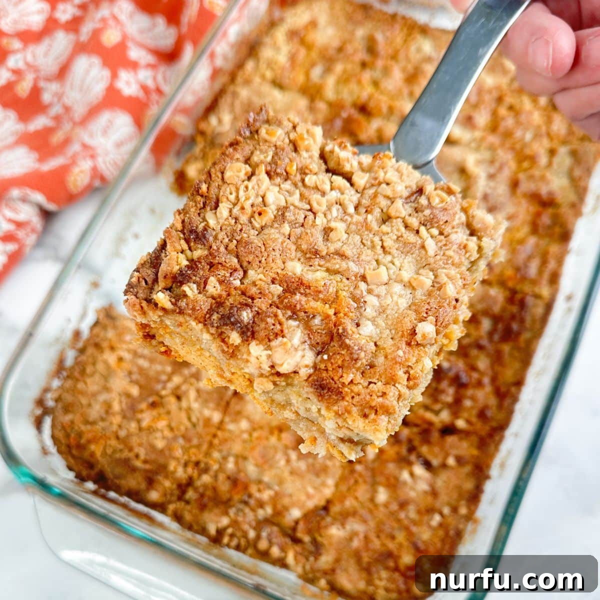Classic Pumpkin Dump Cake with Warm Spices 4 Piece of pumpkin dump cake on a spatula.