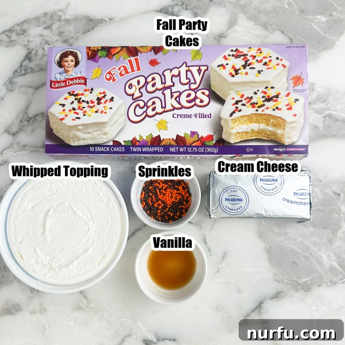 Box of fall party cakes, cream cheese, sprinkles, whipped topping, and vanilla.